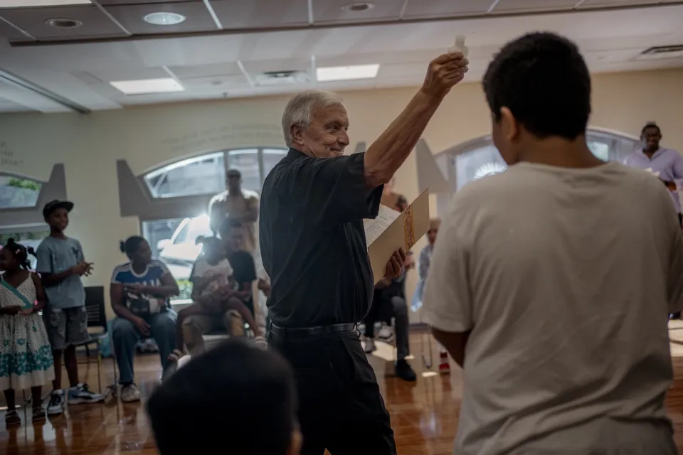 Father Kelly blesses families during the Back-to-School event at Holy Trinity Catholic Church