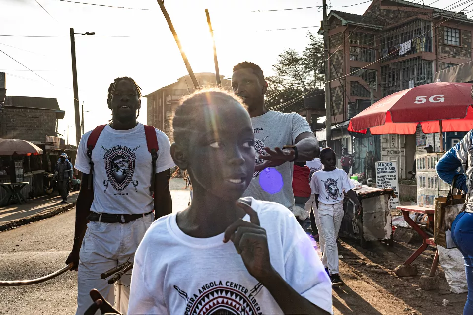 Street gathering with youth in t-shirts during an outdoor performance