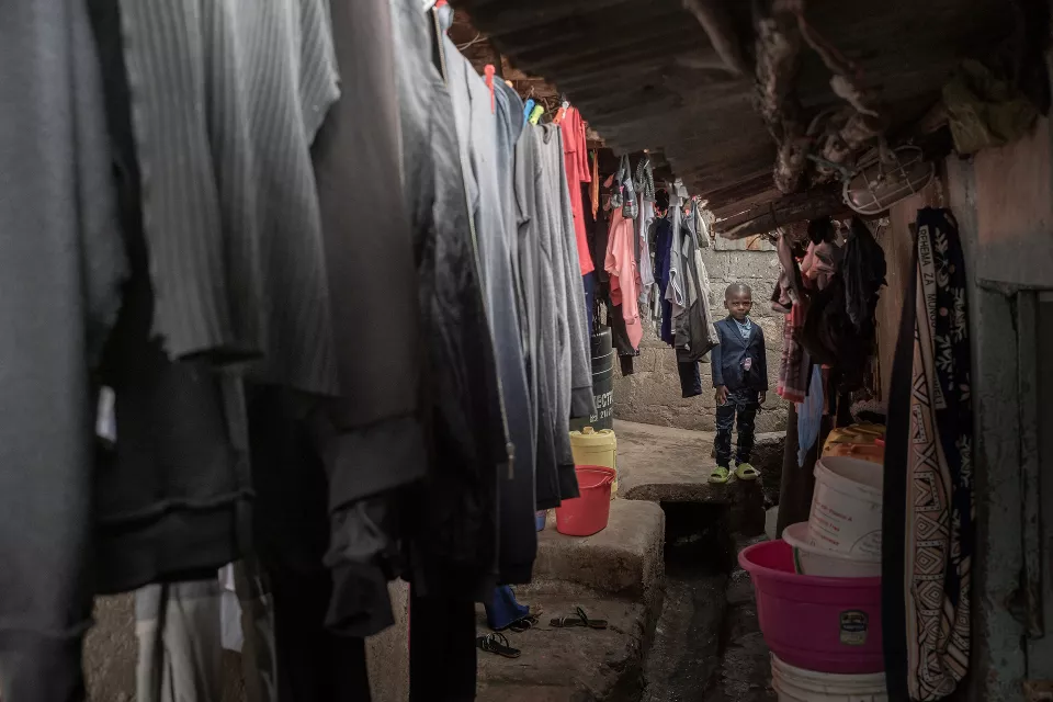 Interior of a modest home showing clothing hanging on lines