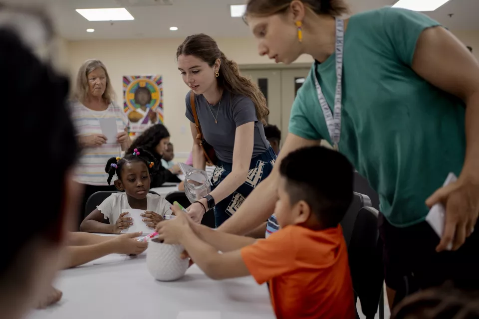 Inside view. Volunteers with migrants children for the Back to School Holy Trinity Catholic Church event in Georgetown, 