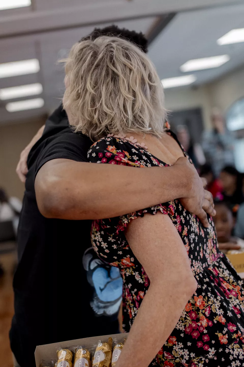 two people embrace in the Holy Trinity Catholic Church